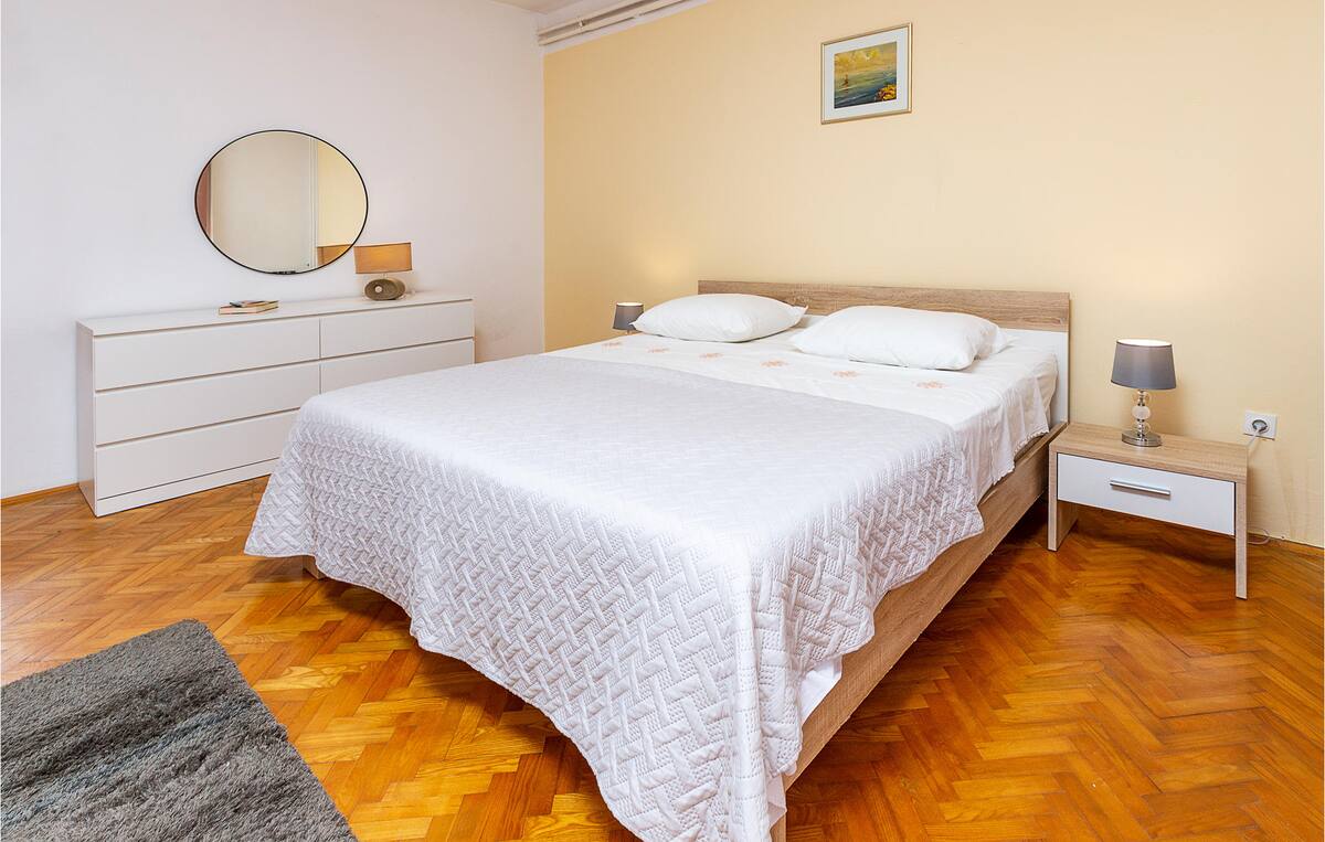 Spacious and bright master bedroom with double bed and light-colored decor