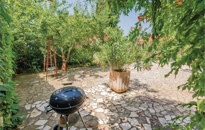 Paved outdoor area with swing and barbecue grill for relaxation and entertainment