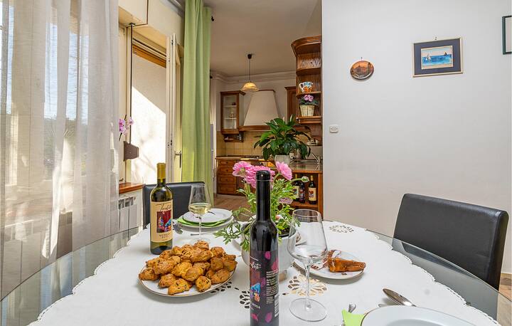 Dining room table with Teraboto wine and olive oil bottles, surrounded by comfortable chairs
